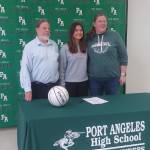 From left, Port Angeles head girls basketball coach Michael Poindexter, Eve Burke and assistant coach Jennifer Rogers at Burke's signing to play for Linfield College in McMinnville, Ore. (Pierre LaBossiere/Peninsula Daily News)