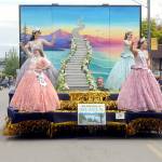 With the theme of Sequim, Our Little Piece of Heaven, the Sequim Irrigation Festival float featuring royalty, clockwise from upper left, Queen Isabella Williams and princesses Katherine Gould, Ellie Turner and Lauren Willis, rolls through downtown Sequim on Saturday. The parade featured more than 90 entries with its return to being an in-person event. Driving the float was Guy Horton. (Keith Thorpe/Peninsula Daily News)