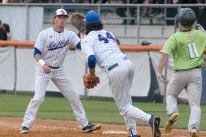Keith Thorpe/Peninsula Daily News
Lefties first baseman Ethan Flodstrom, left, receives a short toss from pitcher Steven Brooks to force out Yakima batter Taylor Holder on an infield dribbler in the third inning on Friday night at Port Angeles Civic Field.