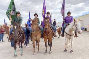 Courtesy photo
High school equestrians Maggie Anderson, left, Sydney Hutton, Libby Swanberg and Joanna Seelye prepare to enter the arena for the Grand Entry at Washington High School Equestrian Team (WAHSET) State Finals.