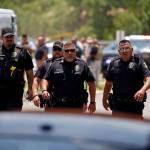 Police walk near Robb Elementary School following a shooting, Tuesday in Uvalde, Texas. (AP Photo/Dario Lopez-Mills)