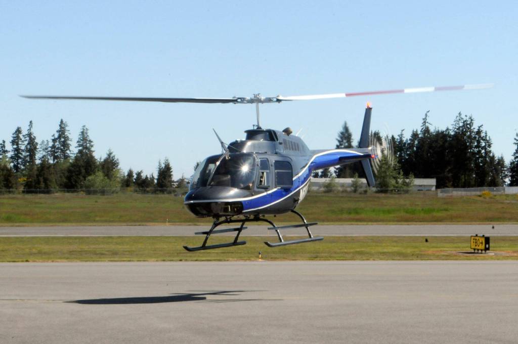 A Bell 206B JetRanger helicopter takes off from the tarmac for a demonstration flight at Fairchild Airport on Saturday. (Keith Thorpe/Peninsula Daily News)