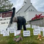 Matthew Nash/Olympic Peninsula News Group

The Rev. ClayOla Gitane, rector at St. Luke’s Episcopal Church, places signs and teddy bears in memory of the 21 victims of Tuesday's mass shooting in Robb Elementary School in Uvalde, Texas.