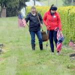 Monica Reynolds, a prospective member of the Daughters of the American Revolution, left, and Lindsey Christianson, a member of the organizations Port Angeles-based Michael Trebert Chapter, locate graves of veterans for adornment with American flags on Saturday for Mondays Memorial Day ceremony at 9:30 a.m. at Mount Angeles Memorial Park, 45 Monroe Road in Port Angeles. (Keith Thorpe/Peninsula Daily News)