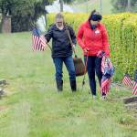 Monica Reynolds, a prospective member of the Daughters of the American Revolution, left, and Lindsey Christianson, a member of the organizations Port Angeles-based Michael Trebert Chapter, locate graves of veterans for adornment with American flags on Saturday for Mondays Memorial Day ceremony at 9:30 a.m. at Mount Angeles Memorial Park, 45 Monroe Road in Port Angeles. (Keith Thorpe/Peninsula Daily News)