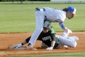 Keith Thorpe/Peninsula Daily News
Lefties second baseman Gabrial De Jesus, top, stuggles to keep his balance after tagging out Northwest's Jesse Bechtold on a steal attemp in the first inning on Friday evening at Port Angeles Civic Field.
