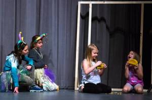 Tricksters played by Mia Buhrer and Matilda Woodbury watch the dragons played by Emma Abken and Bekah Abken eat specially prepared tacos. (Emily Matthiessen/Olympic Peninsula News Group)