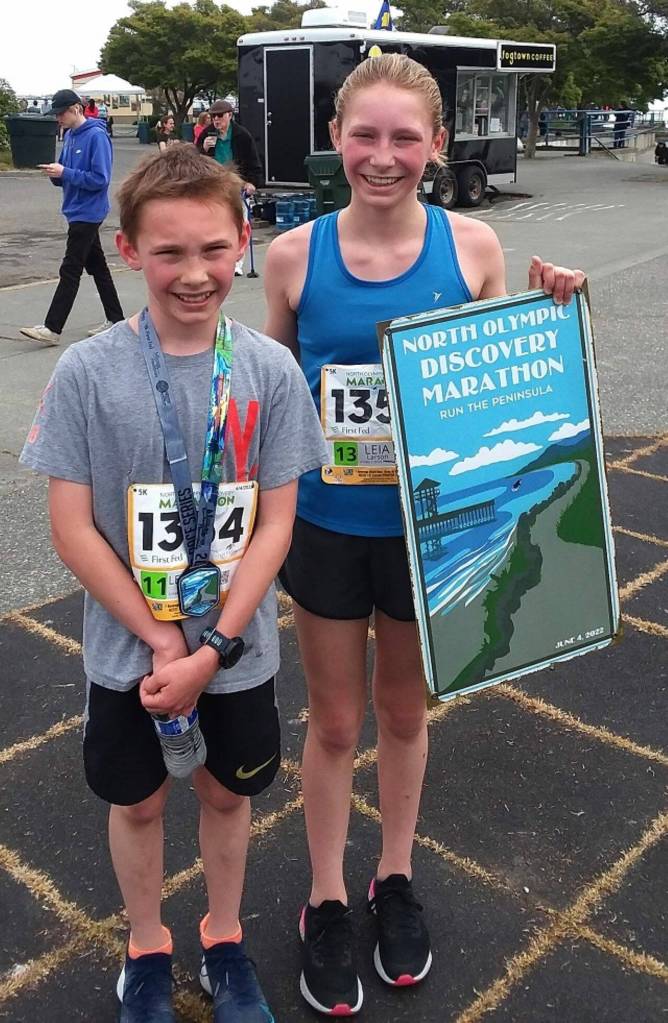 Leyton Larson, 11, and his sister Leia Larson, 13, celebrate finishing the North Olympic Discovery Marathon. Leyton finished 12th while Leia won the womens race. (Pierre LaBossiere/Peninsula Daily News)