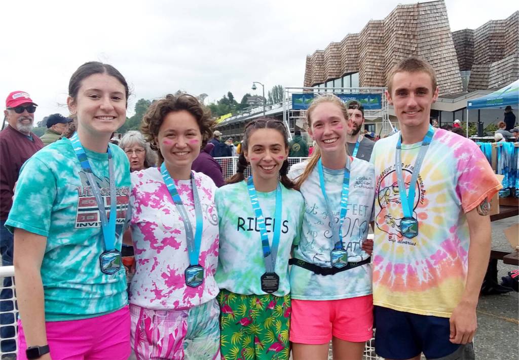 The members of Lactic Addicts celebrate after winning the team relay marathon at the North Olympic Discovery Marathon. From left are Campbell Faust, Sophia Hackett, Kenzie DeLeon, Gracie Long and Alex Solberg. DeLeon and Long are former runners for Port Angeles High School and now run track and cross country at universities in Oregon. (Pierre LaBossiere/Peninsula Daily News)