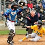 Ben Clemens slides safely into home as the Eagles catcher Felix Gonzales is a little late getting the ball from the outfield to make the tag. Ben Clemens scored the Elks both runs but they came up short as the Eagles flew past them 7 to 2 in the championship game Tuesday at the Lincoln Park complex dlogan