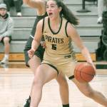 Peninsulas Hope Glasser heads for the lane past Shorelines Gracie Browning on Wednesday at Peninsula College. (Keith Thorpe/Peninsula Daily News, 2021 file)