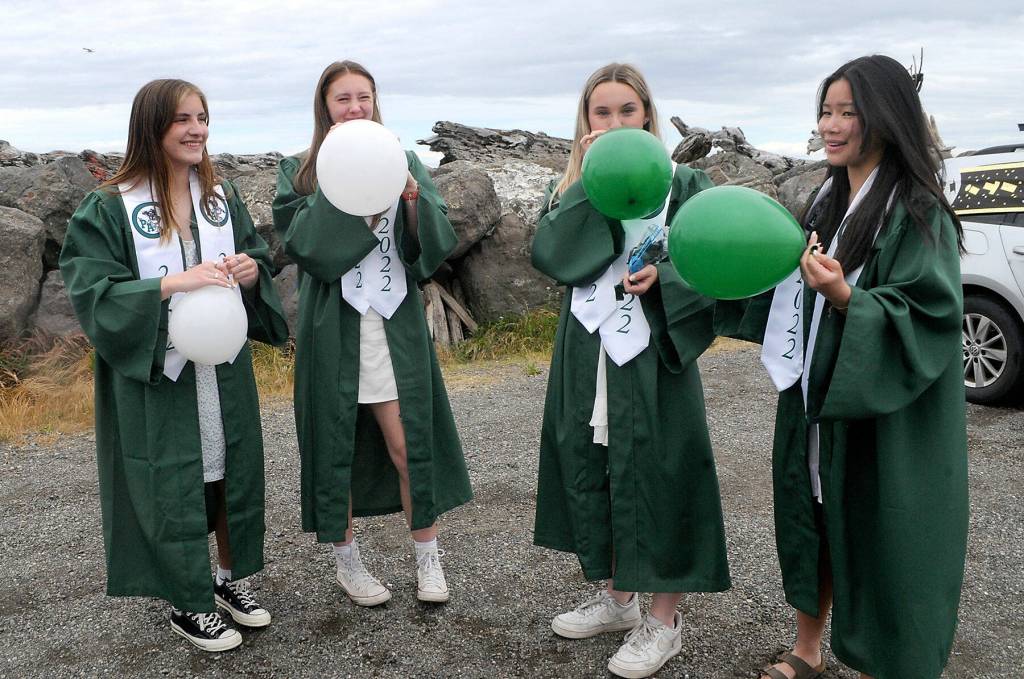 Port Angeles High School graduates, from left, Hannah Basden, Zoe Smithson, Peyton Rudd and Jenna McGoff inflate balloons that will adorn a car taking part in Fridays graduation parade through the streets of Port Angeles from Ediz Hook to the high school. (Keith Thorpe/Peninsula Daily News)