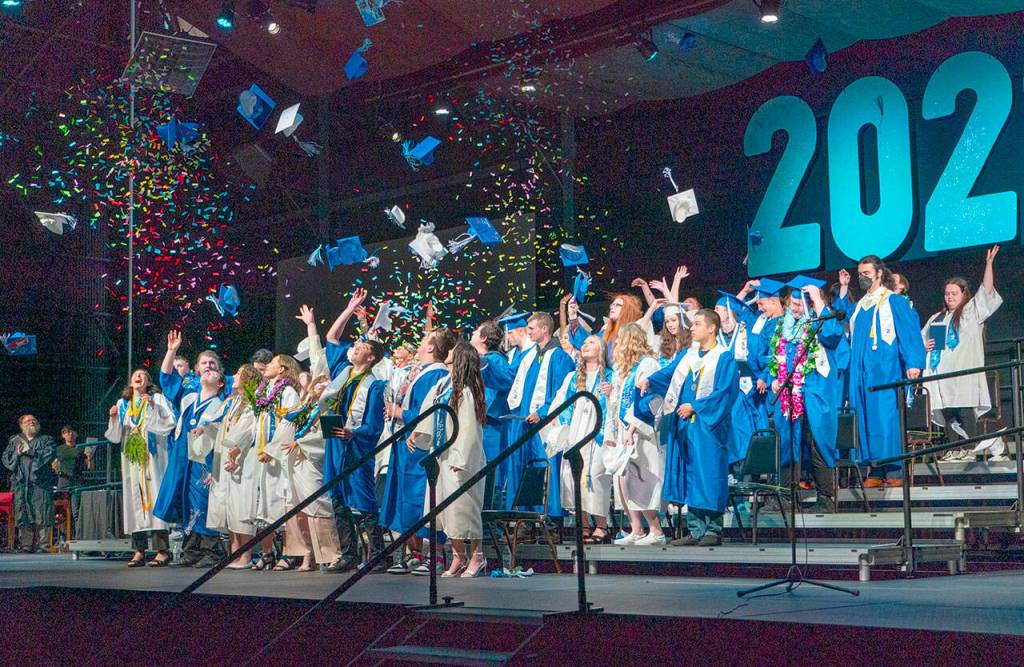 Hats and confetti take to the air at the end of the Chimacum High School graduation ceremony at Fort Wordens McCurdy Pavilion on Saturday. Fifty-four seniors were awarded diplomas, marking the end of their high school careers. (Steve Mullensky/for Peninsula Daily News)