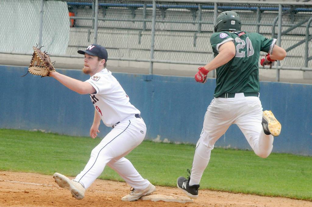 Wilder first baseman Ezra Townsend, left, waits for the throw from the infield as Lakeside Recovery batter Luca Migliore nears the bag on Saturday in Port Angeles. (Keith Thorpe/Peninsula Daily News)