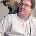 Ryan Malane with one of his cats.