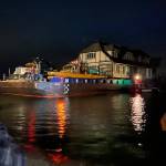 A crowd gathers late on June 8 to watch Martha Vaughans new home be delivered by Nickel Bros crew members to its new home on 3 Crabs Road. (Photo courtesy Jeff McCord, Nickel Bros)