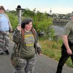 Special Olympian Deedra Hunter of Port Angeles takes a turn carrying the torch accompanied by fellow Olympian Bonny Ann Cates, left, and Chief Criminal Deputy Brian King of the Clallam County Sheriffs Office during Wednesdays Law Enforcement Torch Run along a section of the Waterfront Trail in Port Angeles. The relay, which included representatives from the sheriffs offices in Clallam and Jefferson counties, Port Angeles and Sequim police, tribal police from Lower Elwha Klallam and Jamestown SKlallam, State Patrol, Quilcene firefighters, U.S. Border Patrol, state parks personnel and Olympic National Park rangers, as well as several Special Olympians, followed a route from the west side of Port Angeles at 7 a.m. to the Hood Canal Bridge to about 5 p.m. in support of Special Olympics, which provides sports training and athletic competition for individuals with disabilities. (Keith Thorpe/Peninsula Daily News)