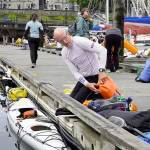 Bob McCall, from Great Britain, loads his kayak with supplies he will need for his 710-mile journey to Ketchikan, Alaska, during the 2022 Race 2 Alaska, which got underway at noon Thursday from Victoria Harbour. A self-described tracker junkie since the first race, McCall decided to enter the race in 2020 and ordered a kayak built in Victoria, but COVID-19 hit and canceled everything. This is the first time he was able to enter and he is looking forward to the adventure. (Steve Mullensky/for Peninsula Daily News)