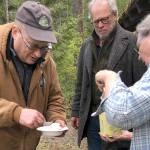 Photo by Kris Lenke
BCH Buckhorn Range member and Dutch Oven “Queen” Kim Merrick serves
dessert to Martin Knowles (WTA) and fellow chapter member Larry Sammons
during a LaBar/Skok trail clearing work party.