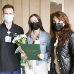 Aaron Possin, left, and Vickie Swanson, right, present a DAISY Award to Elizabeth Hornsey, an RN in Olympic Medical Centers emergency department.