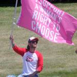 A Port Angeles man who prefers to be unidentified waves a pro-choice flag in front of the Clallam County Courthouse on Saturday. (Keith Thorpe/Peninsula Daily News)