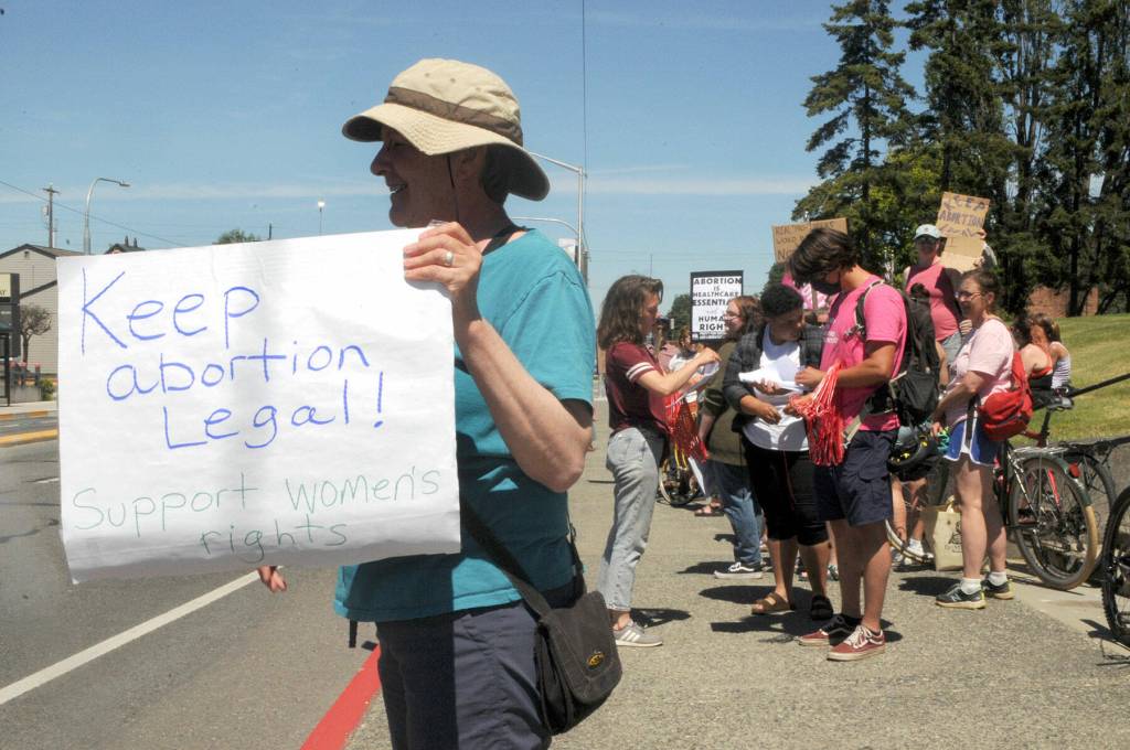 Carole Scholl of Port Angeles shows her support for womens rights during Saturdays rally. (Keith Thorpe/Peninsula Daily News)