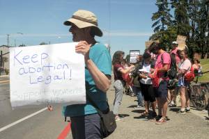 Carole Scholl of Port Angeles shows her support for womens rights during a rally Saturday following the U.S. Supreme Courts decision to overturn Roe v. Wade. For more on the rallies in Port Angeles, Sequim and Port Townsend, see Mondays print and online editions. (Keith Thorpe/Peninsula Daily News)