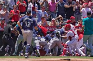 Several members of the Seattle Mariners and the Los Angeles Angels scuffle after Mariners' Jesse Winker was hit by a pitch during the second inning of a baseball game Sunday, June 26, 2022, in Anaheim, Calif. (AP Photo/Mark J. Terrill)
