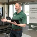 Clint Ostler, president of Dash Air Shuttle, announces details of the startup airlines plans to begin service between Port Angeles and SeaTac Airport in Seattle during a gathering of Port of Port Angeles commissioners and others on Tuesday at William R. Fairchild International Airport. (Keith Thorpe/Peninsula Daily News)