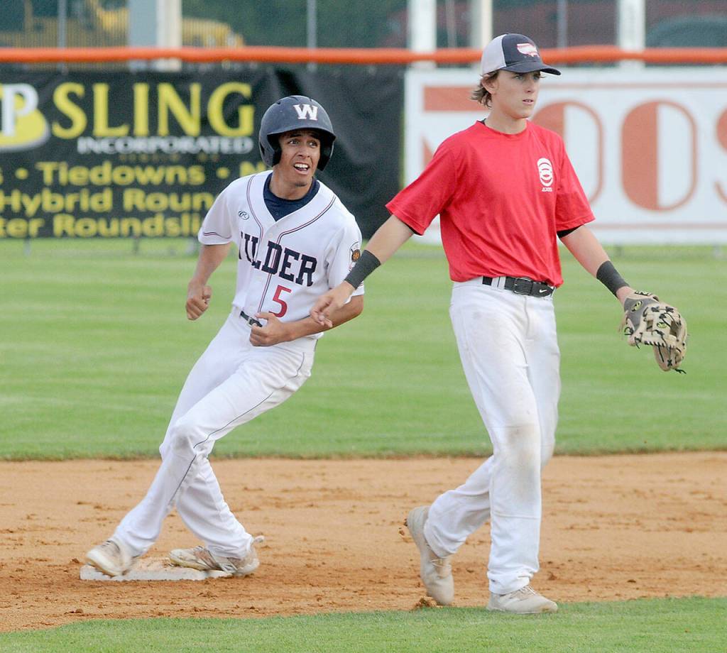 Keith Thorpe/Peninsula Daily News Wilder Seniors Cole Johnson cruises into second on a steal in the third inning on Thursday as WBC Colts Red second baseman Zac Durben watches for the ball from home plate at Port Angeles Civic Field.