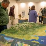 Visitors get a look at the Dungeness River Nature Centers 3-D Dungeness River watershed table relief map. The center hosts open houses this week. (John Gussman/Jamestown SKlallam Tribe)