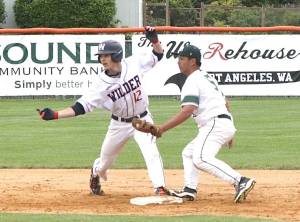 Wilder Senior's Landon Seibel looks back at the umpire as he is called safe at second base as Lakeside BR's Ethan Babauta puts the tag on Seibel on Sunday in the Dick Brown Memorial Tournament semifinal. Wilder Senior won 15-5 to advance to the championship game, which was won by WBC Colts Black. (Dave Logan/for Peninsula Daily News)