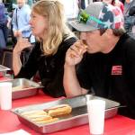 Brandon Elliott, right, of Port Angeles, ate 7 1/2 hot dogs to win a contest Monday next to the Wharf in downtown Port Angeles. Richard Wright, left, of Port Angeles finished second and K.T. Nall of Santa Barbara, Calif., placed third. (Dave Logan/for Peninsula Daily News)