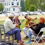 After a three-year hiatus, the popular Fiddle Tunes is back at Centrum with workshops and performances culminating in a Fiddle Tunes finale on Littlefield Green at Fort Worden State Park on Saturday. Sharing tunes at Fort Worden Commons on Tuesday afternoon are, from left: WB Reid of Seattle, Paul Rangell and son Benny of Santa Cruz, Calif., and Suzy Thompson of Berkeley, Calif. Thompson is a past Artistic Director of the Fiddle Tunes. (Steve Mullensky/for Peninsula Daily News)