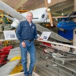 Steve Mullensky/for Peninsula Daily News

Michael Payne, Executive Director of the Port Townsend Aero Museum, shows off some of the antique and historic air planes on display at the museum located at the Jefferson County International Airport in Port Townsend. The museum is expanding, in the area behind the blue tarp in the background, to increase the museum’s display area by about a third.