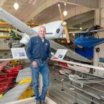 Michael Payne, Executive Director of the Port Townsend Aero Museum, shows off some of the antique and historic air planes on display at the museum located at the Jefferson County International Airport in Port Townsend. The museum is expanding, in the area behind the blue tarp in the background, to increase the museums display area by about a third. (Steve Mullensky/for Peninsula Daily News)