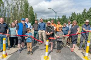 Steve Mullensky/for Peninsula Daily News


Jefferson County Commissioner, District 2, Heidi Eisenhour, cuts the ribbon to open a “Safe Routes to School” pathway to Chimacum Creek Primary School from Cedar Avenue in Port Hadlock on Wednesday. The project, funded with an $880,000.00 grant from the Washington State Department of Transportation, includes a new mile long sidewalk on Cedar Avenue, that had no walkable sidewalk, and a paved trail leading to the school which was previously a dirt strip and soon, covered bus stops.