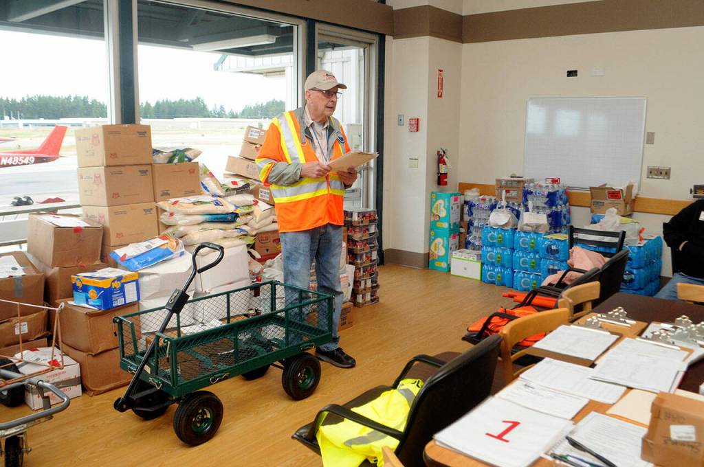 DART safety officer Dave Woodcock conducts a pilots briefing at William R. Fairchild International Airport prior to Saturdays airlift exercise to five Clallam County airfields. (Keith Thorpe/Peninsula Daily News)