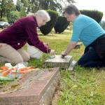 Volunteers Ginger Sanford, left, and Vicki Hansen, both of Port Angeles, carefully scrub a military veterans headstone at Mount Angeles Memorial Park in Port Angeles on Saturday. The Michael Trebert Chapter of the Daughters of the American Revolution hosted a training seminar and workshop on the do no harm method cleaning and preserving grave markers. The workshop was held in preparation for a Wreaths Across American Wreath Laying ceremony scheduled for Dec. 17. (Keith Thorpe/Peninsula Daily News)
