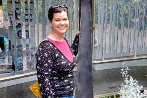 Karen Sixkiller poses with her Water Spider sculpture.