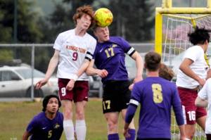Sequims Aidan Henninger, right, vies for a header with a Kingston defender during a game in April. (Michael Dashiell/Olympic Peninsula News Group)
