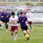 Sequims Brandon Wagner, right, dribbles upfield during a game against Kingston in April. (Michael Dashiell/Olympic Peninsula News Group)