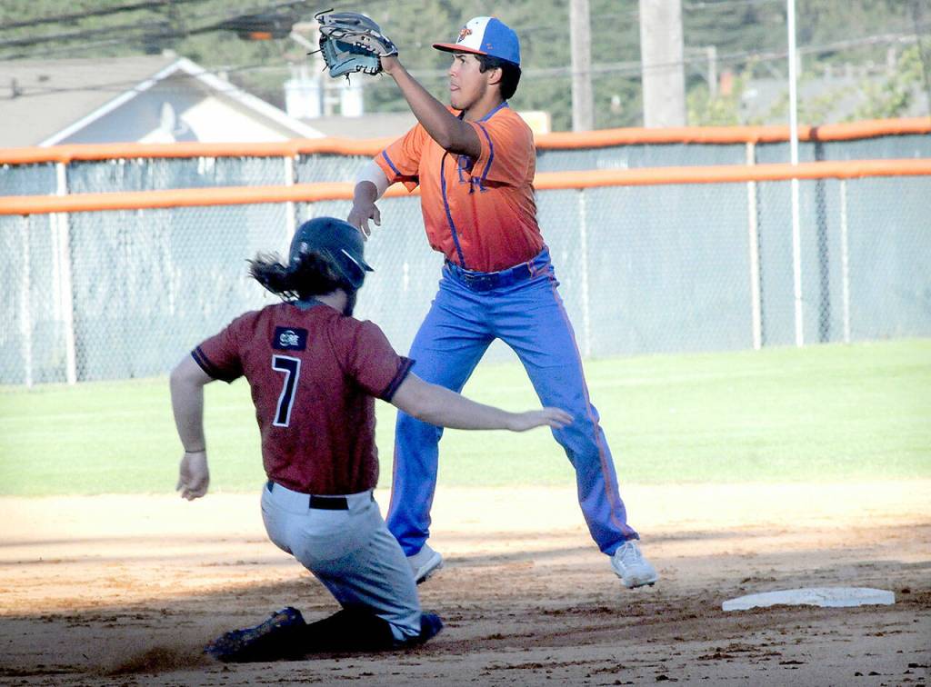 Keith Thorpe/Peninsula Daily News Lefties second baseman Isaiah Munoz, top, tries to cut off a steal by Redmonds Josh Parks on Thursday at Port Angeles Civic Field.