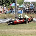 Island hopper safety personnel race to the Starts & Stripes boat after driver Burt Roberts and navigator Nichole Heaton left the Extreme Sports Park track and crashed nose-first through a safety fence on Saturday during sprint boat races in Port Angeles. The crew was apparently uninjured in the incident and the boat was later trailered back to the pits. (Keith Thorpe/Peninsula Daily News)