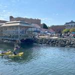Steve Mullensky/for Peninsula Daily News

Kayakers find a cool way to beat the heat and listen to live music during Thursday’s Concert on the Dock at Pope Marine Park in Port Townsend. Another concert is set this coming Thursday when temperatures are expected to have dipped to temperatures more commonly felt on the North Olympic Peninsula.