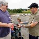Scott Miller, left, of Silverdale points to the undersized rock crab that Tom Price of Spanaway is holding. Both men were crabbing off the Marine Science Center pier at Fort Worden on Thursday. The other crab was barely legal size, and Price put both back into the sea. (Steve Mullensky/for Peninsula Daily News)