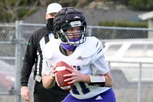 Sequim quarterback Lars Wiker wears a Guardian Cap during a spring 2021 game at North Kitsap. The Wolves have worn Guardian Caps in practice for a number of seasons. The NFL is requiring players to wear the caps during training camp to reduce potential impacts to players' brains.