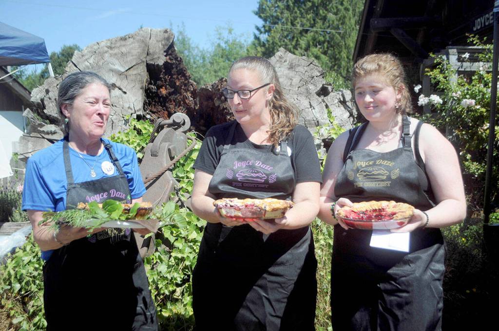 Winners of the annual Joyce Daze blackberry pie contest, from left, Ann Ravagni of Joyce in first place, Rachel Rice of Joyce in second and Ariana Varholla of Sequim in third celebrate their victory after judging. Eleven pies were entered in this years competition. (Keith Thorpe/Peninsula Daily News)