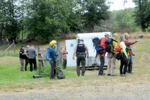 A Jefferson County Search and Rescue team waits at a Jefferson County Sheriffs Office command post as plans are developed to access the site of a plane crash on Wednesday southwest of Gardiner. (Keith Thorpe/Peninsula Daily News)
