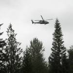 A rescue helicopter from Naval Air Station Whidbey Island circles the area where a plane crashed on Wednesday in forested terrain southwest of Gardiner. (Keith Thorpe/Peninsula Daily News)